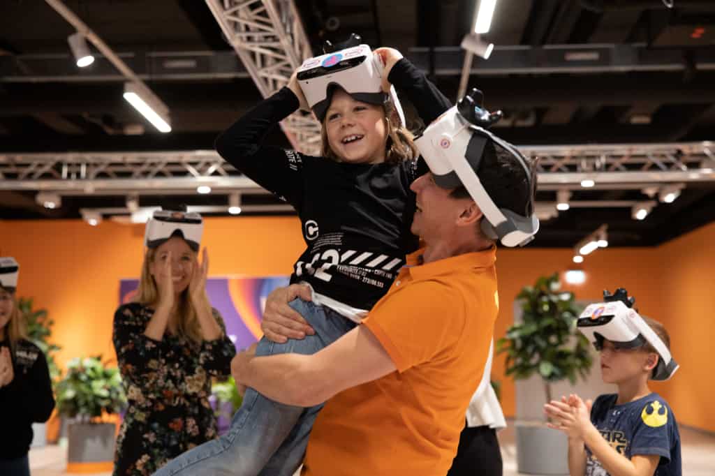Man holding his son using VR headset